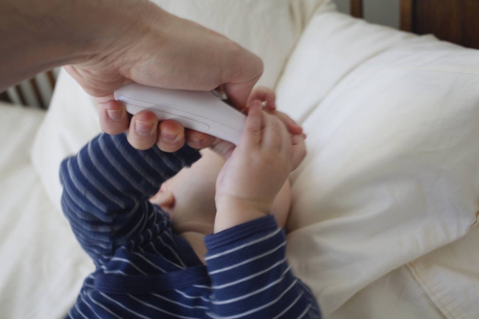 Baby struggling with thermometer